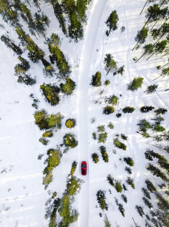 aerial-view-of-red-car-driving-through-the-white-s-NBZCPLJ-scaled.jpg